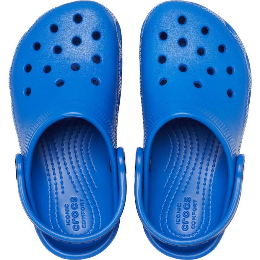 A pair of Crocs Kids - Classic Clog K Blue Bolt Toddlers, viewed from above, features bright blue perforated uppers, textured footbeds, and adjustable heel straps made from signature Croslite material., 196265146345, 196265146352, 196265146369, 1962651463
