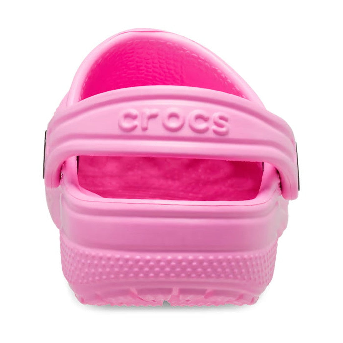 A close-up rear view of the Crocs Kids Youths - Classic Clog K in Taffy Pink highlights the heel strap with a raised CROCS logo and the textured, water-friendly sole., 191448893788, 191448893795, 191448893801, 191448893818, 191448893825, 191448893832, 191