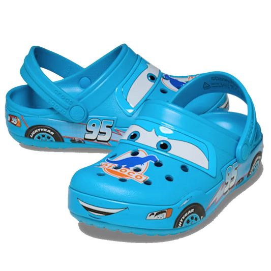 A pair of Crocs Kids Classic Clogs Lightning McQueen Dinoco Blue, designed for kids in the classic clog style and featuring a cartoon car face, number 95, and racing details inspired by the movie Cars.