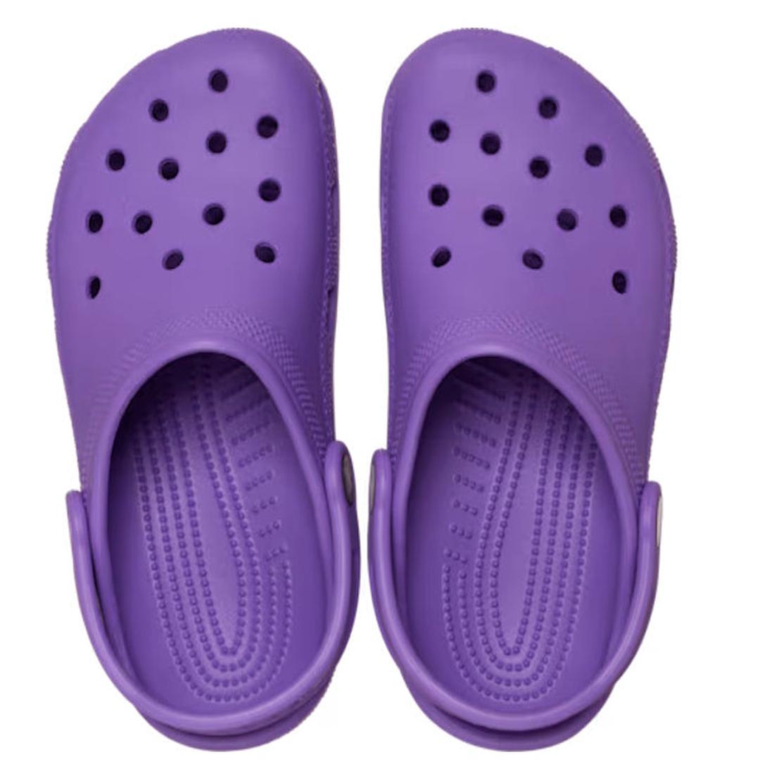 A pair of Crocs Kids Toddlers - Classic Clog Purple in toddler sizes features ventilation holes and adjustable heel straps, shown from above on a white background—ideal water-friendly shoes for little feet., 49897, 49898, 198445337253, 198445337260, 19844