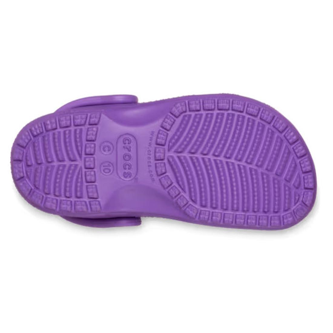 The image displays the sole of the Crocs Kids Toddlers - Classic Clog Purple, showcasing its textured tread and central logo—emphasizing the grip and style of these water-friendly toddler sandals., 49897, 49898, 198445337253, 198445337260, 198445337277, 1