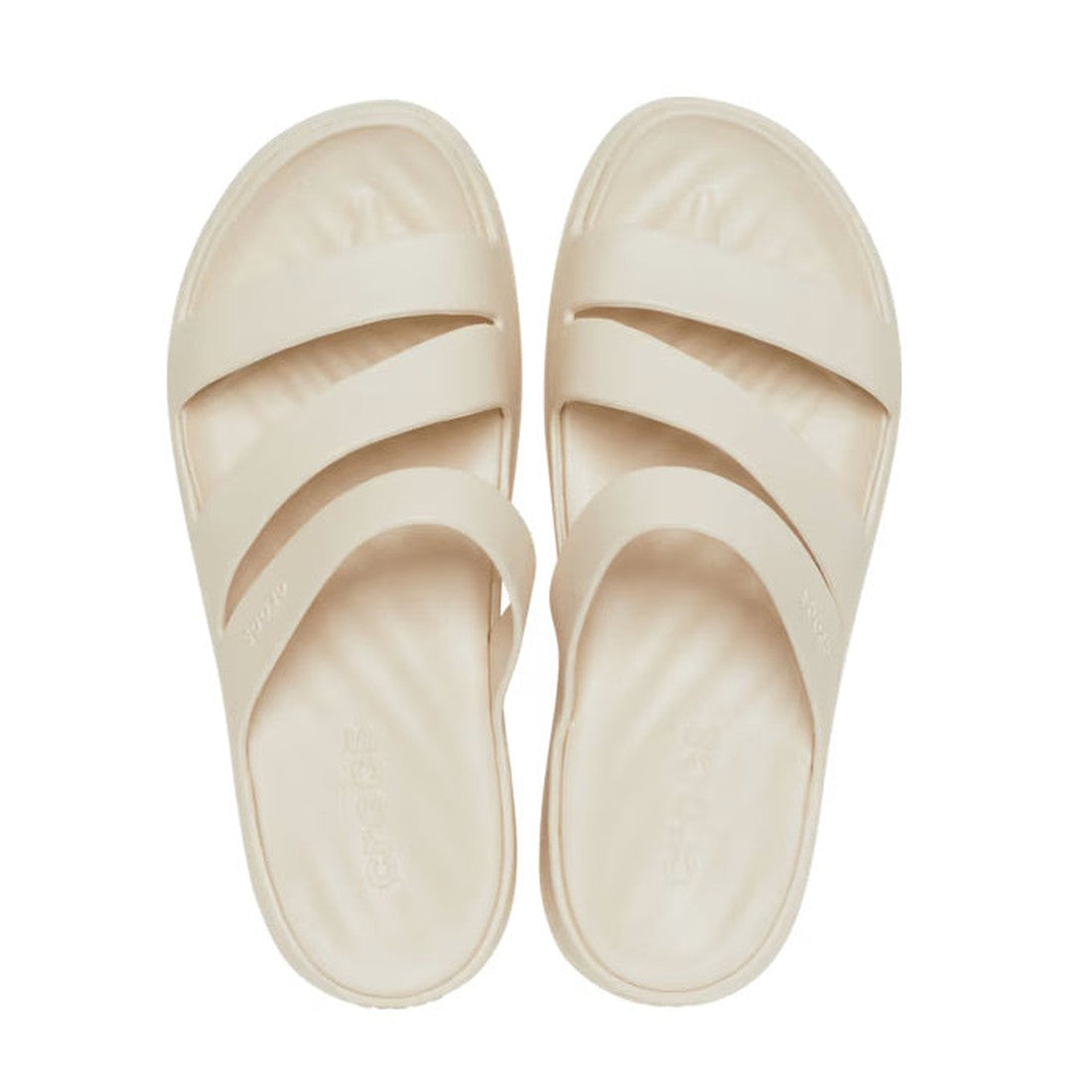A pair of Crocs - Womens Getaway Strappy Slide Sandal Stucco Bone with two wide crisscross straps and Free Feel Technology, from the Crocs Getaway Collection, shown from above on a white background., 39578, 196265540792, 196265540808, 196265540815, 196265