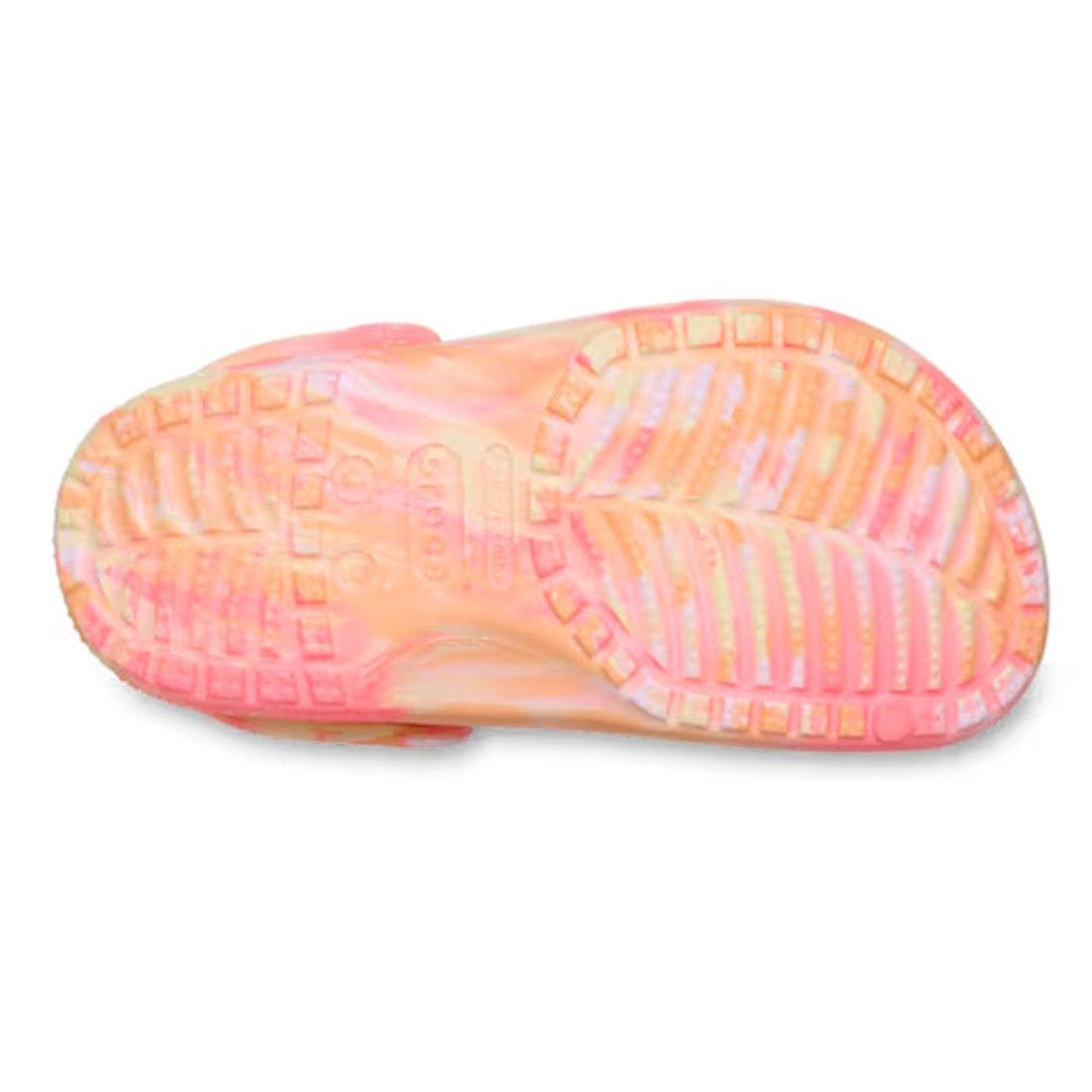 The image displays the sole of the Crocs Kids - Marbled Clog Sandal Guava Pink Multi Youths, featuring pink and orange marbling. Its tread includes ridges and circular indentations for grip, inspired by the classic Crocs clog design., 198445354540, 198445
