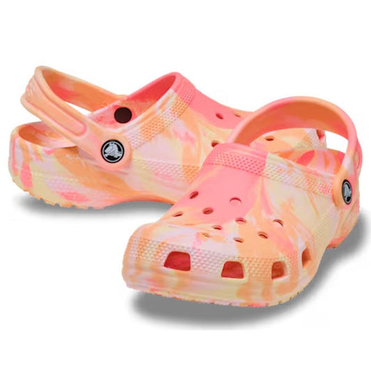 The Crocs Kids - Marbled Clog Sandal Guava Pink Multi Youths features a playful marbled pink and orange design, heel straps, ventilation holes, and textured soles—perfect for adding fun style to any child’s wardrobe.