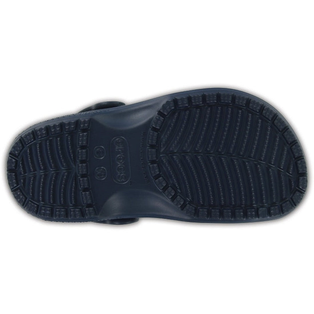 The image shows the bottom of the Crocs Kids - Classic Clog K Navy Youths, featuring a textured, non-slip Croslite sole with a herringbone tread pattern and raised edges for improved grip., 191448735002, 191448735019, 191448735026, 191448735033, 191448735