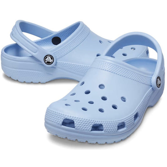 The Crocs - Classic Clog Blue Calcite Adults features ventilation holes on top and adjustable heel straps, shown in light blue on a white background.