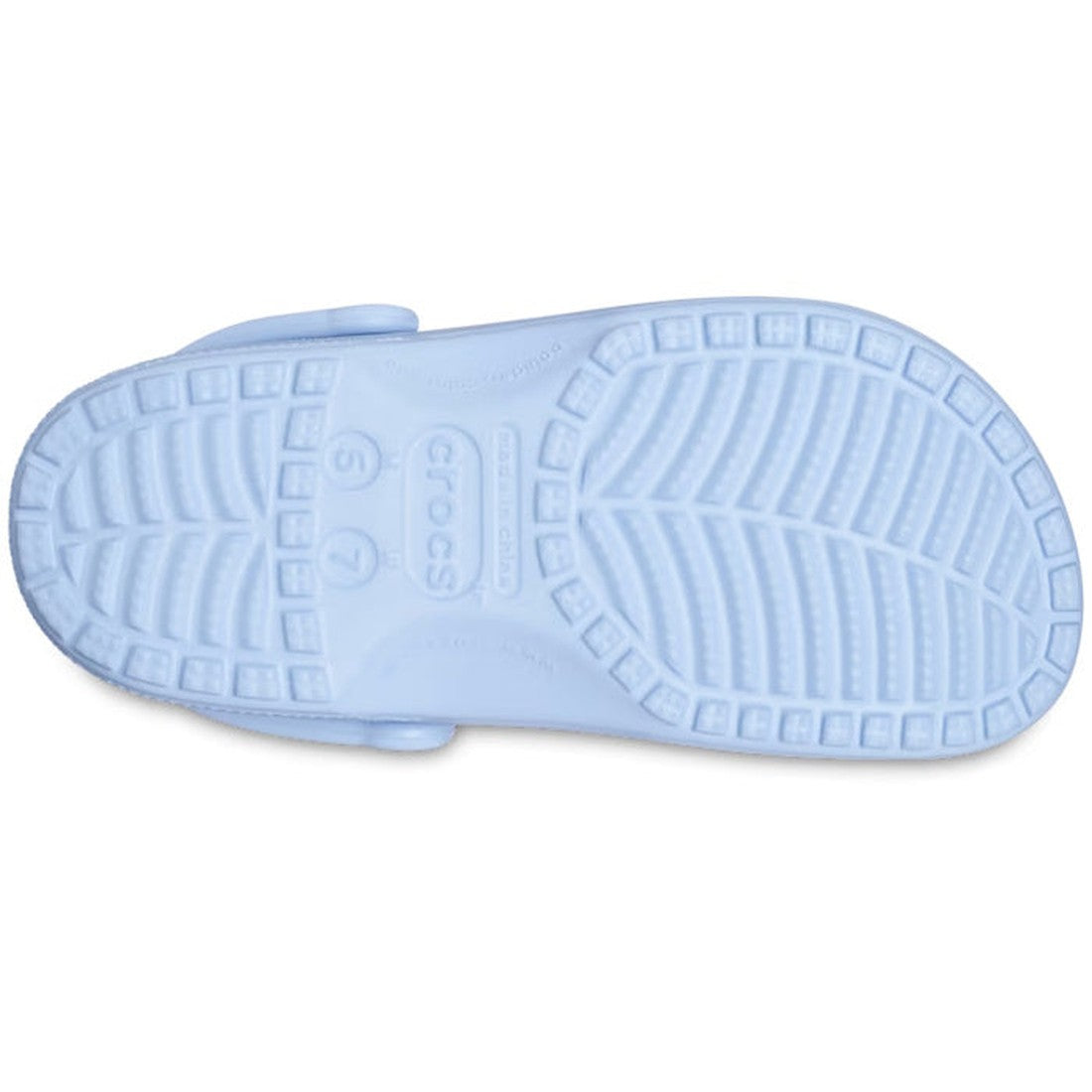 The image shows the bottom view of a Crocs - Classic Clog Blue Calcite Adults shoe, featuring a textured sole with grooves and the Crocs logo at the center., 196265406951, 196265406968, 196265406975, 196265406982, 196265406999, 196265407002, 196265407019,