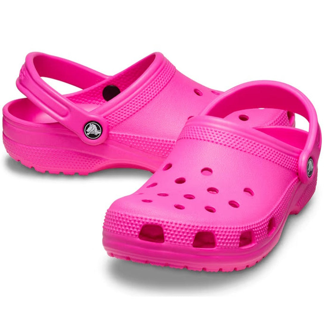 A pair of Crocs - Classic Clog Pink Crush Adults, unisex summer shoes with a back strap and top and side ventilation holes, displayed on a white background.
