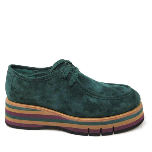 The Django & Juliette Gnota Forest Green Lace Up Moc Platform Shoe features chunky forest green suede, matching laces, and a thick tan, purple, green, and black striped sole with a bold textured finish for a modern look.