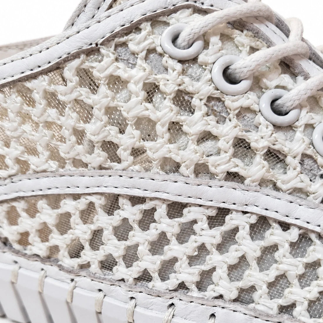 Close-up of Django & Juliete Hamburger White Syn Raffia Leather Sneakers featuring a woven, net-like pattern, white laces, and detailed stitching.