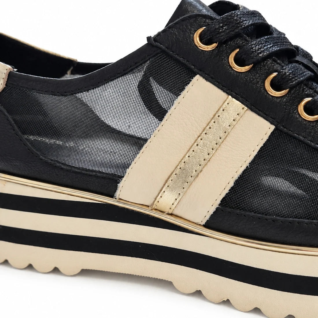 Close-up of the Django & Juliette Eminta Platform Shoe Sheer Leather Black Milk Lace Up featuring beige stripes, gold accent, sheer side panels, and a chunky beige and black striped serrated platform sole.