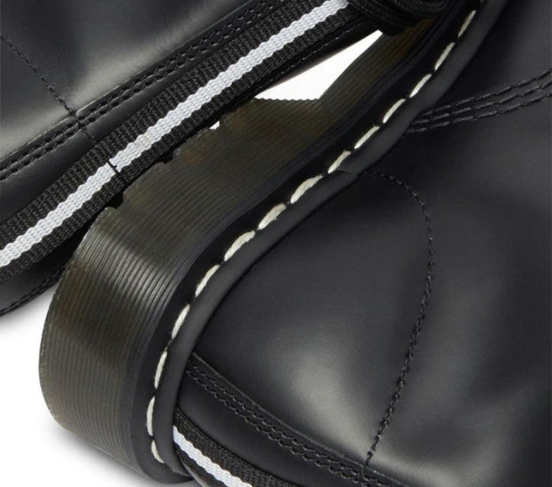 Close-up of two Dr Martens 1460 Disrupt Hardware 8 Eye Boot Black White, featuring thick translucent soles, white stitching, and a black-and-white striped pull tab., 22281, 22292, 22293, 190665448887, 190665448894, 190665448917, 190665448924, 190665448931