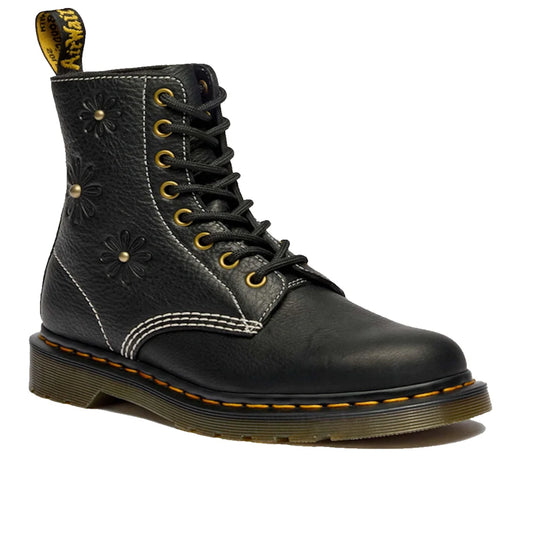 The Dr Martens Women's 1460 Pascal Flower Black Grizzly Leather Boot features yellow stitching, embossed floral details, white stitching accents, a back loop, and a thick translucent brown sole.