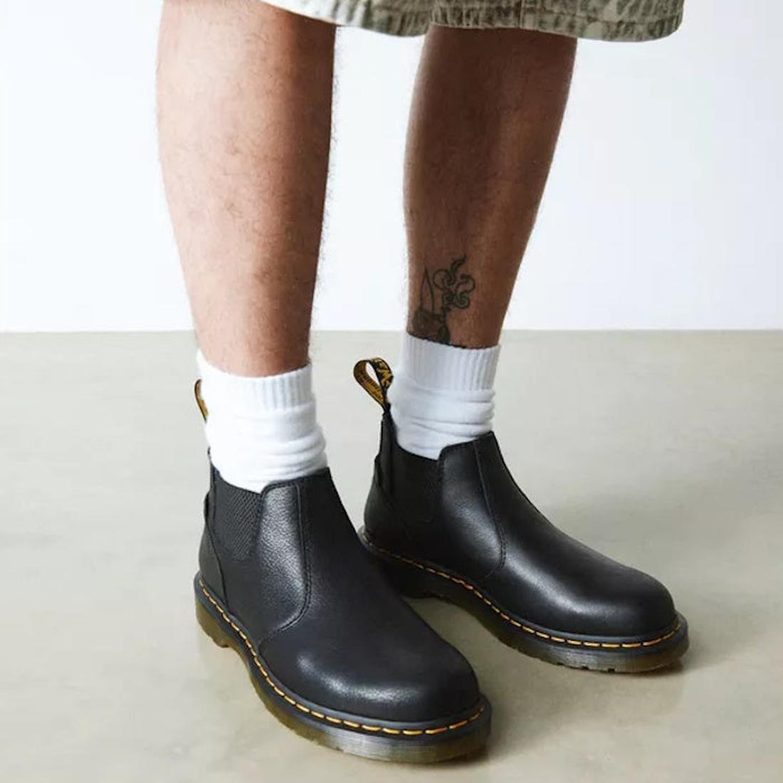 A man, front  wearing long shorts and Dr Martens crop chelsea boots in black and white crew length socks. Showing the height of the boots as just being over ankle height.,,
190665701937,
190665701944,
190665701968,
190665701975,
190665701982,
190665702002