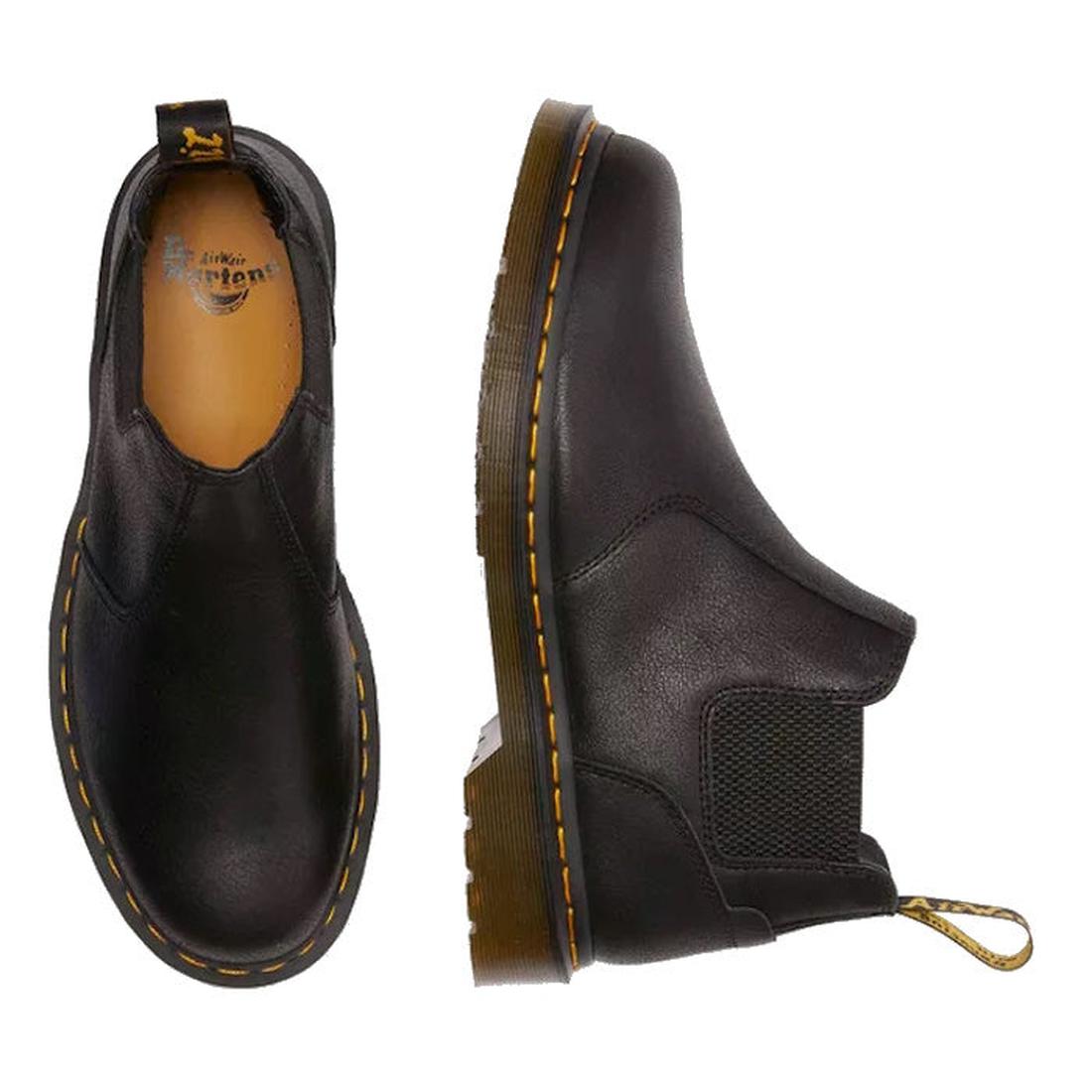 A pair of Dr Martens Crop low height chelsea boots in black leather showing one foot top down and  the other foot side on with the small elastic gussey and pull on tabs., 190665701937,
190665701944,
190665701968,
190665701975,
190665701982,
190665702002,,