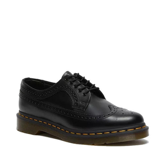 The right foot of a  black polished leather Doc Martens 3989 brogue shoe e eye lace up with yellow stitching and a wingtip design showing the outer side and front of the foot.,
883985987371,
883985987388,
883985987395,
883985987425,