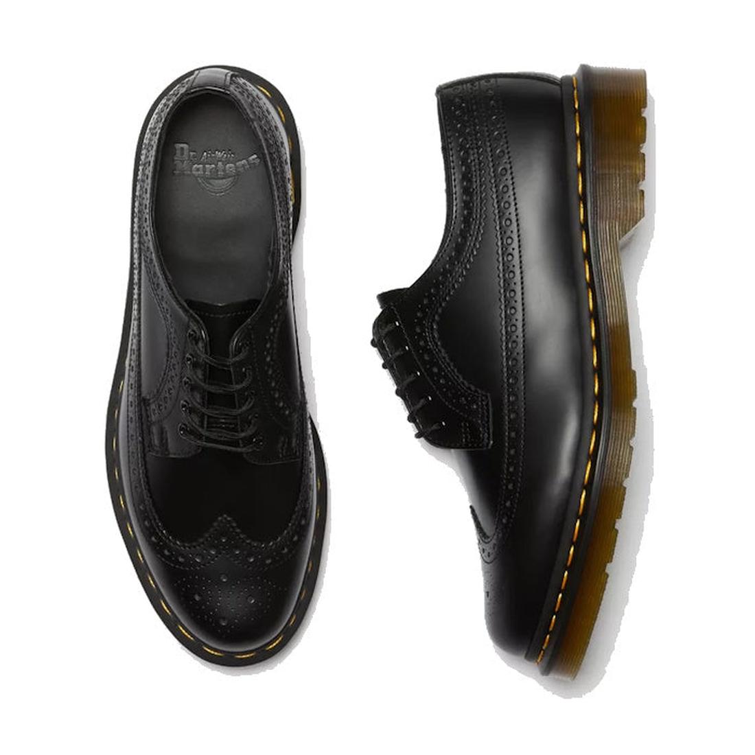 a shot of the right foot top down showing the brogue detailing over yhe toe and the side view of the fet foot shwoing the brouge detailing down the side of a Dr Martens leather 5 eye 3989 shoe.,
883985987371,
883985987388,
883985987395,
883985987425,, 443