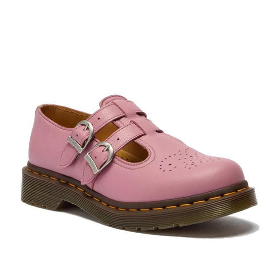 The Dr Martens 8065 2 Strap Mary Jane Shoe in Dusky Rose Pink features Virginia leather, two silver buckles, a perforated toe, and a thick brown sole with signature yellow stitching.