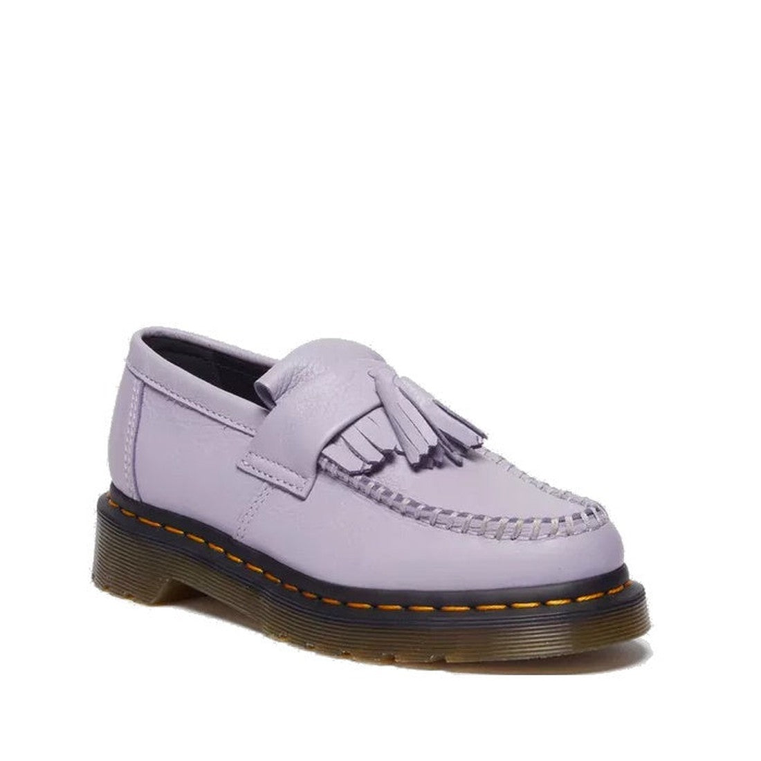 The Dr Martens Adrian Lavender Frost Virginia Leather Tassel Loafer features a thick sole, yellow stitching, moccasin-style toe, and fringe with tassel details on top, shown here against a white background.