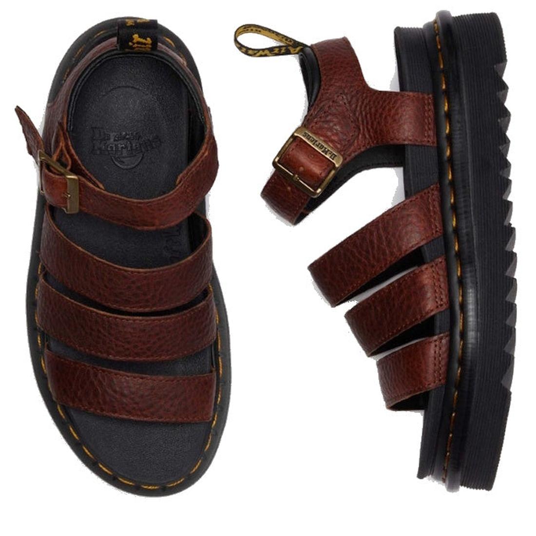 The Dr Martens 3 Strap Blaire Sandal in Cashew Ambassador Leather Tan features brown strappy uppers, black ridged soles, yellow stitching, a buckle, and heel loop tab—combining style with lightweight comfort., 190665772005, 190665772012, 190665772029, 190