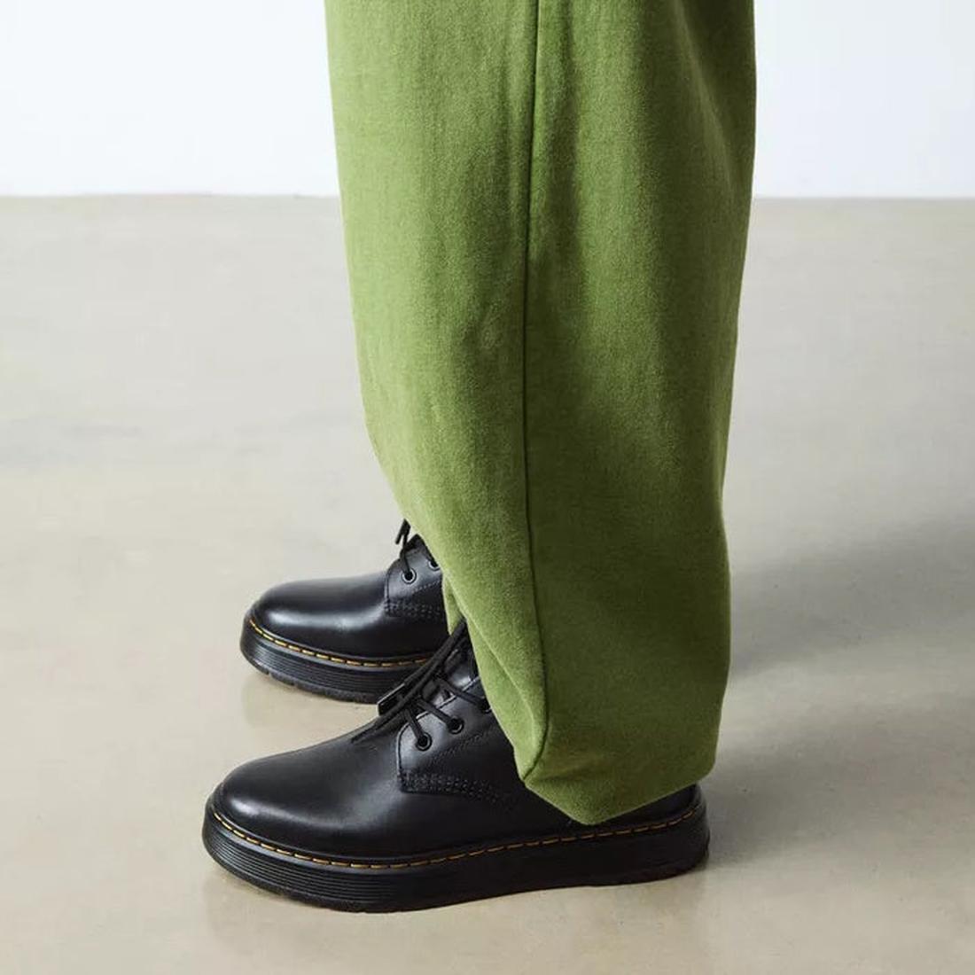Person wearing green pants and black dr amrtens brookline boots  shoes on a neutral background,
190665752700,
190665752717,
190665752731,
190665752748,
190665752755,
190665752779,, 45947, 190665752700, 190665752717, 190665752731, 190665752748, 19066575275