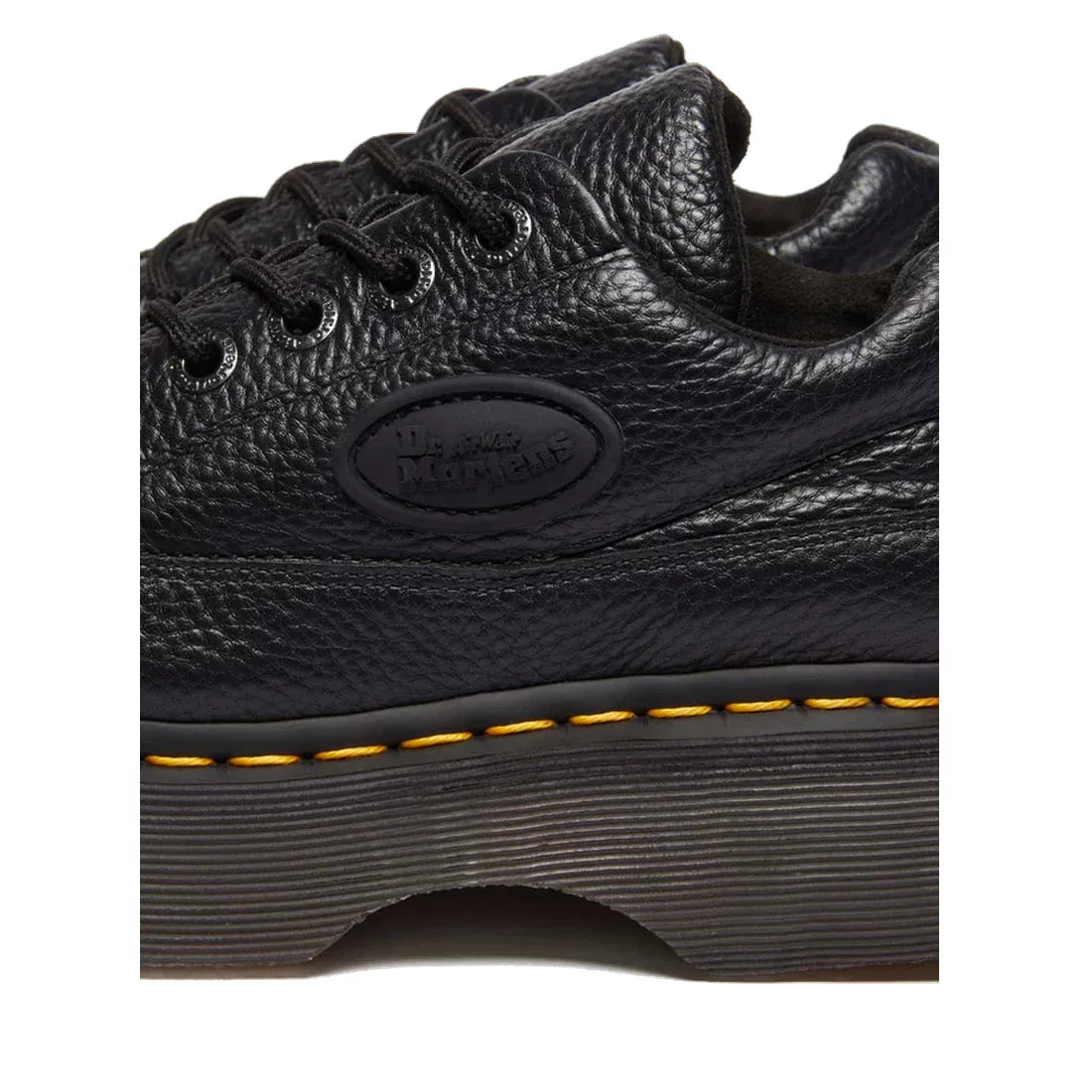 Close-up of the Dr Martens Buzz 5i Milled Nappa Black Leather 5 Eye Shoe, featuring a thick textured sole, signature yellow stitching, embossed logo, and durable Goodyear-welted construction in soft Milled Nappa leather., 51613, 190665702798, 190665702804