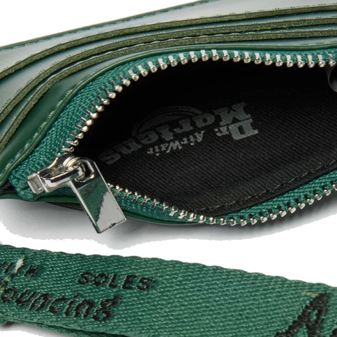 Close-up of the Dr Martens Card Holder Keyring Bag Charm in green Kiev leather, featuring green stitching, a black interior with AirWair logo, a branded fabric strap, and a zippered coin compartment.