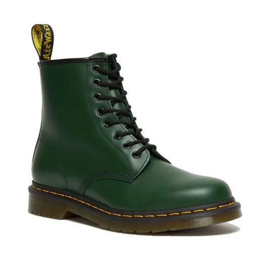 The 1460 Dr. Martens Smooth Green Leather 8 Up Boot features black laces, yellow stitching on an air-cushioned sole, and a branded pull tab—classic elements of the iconic style.
