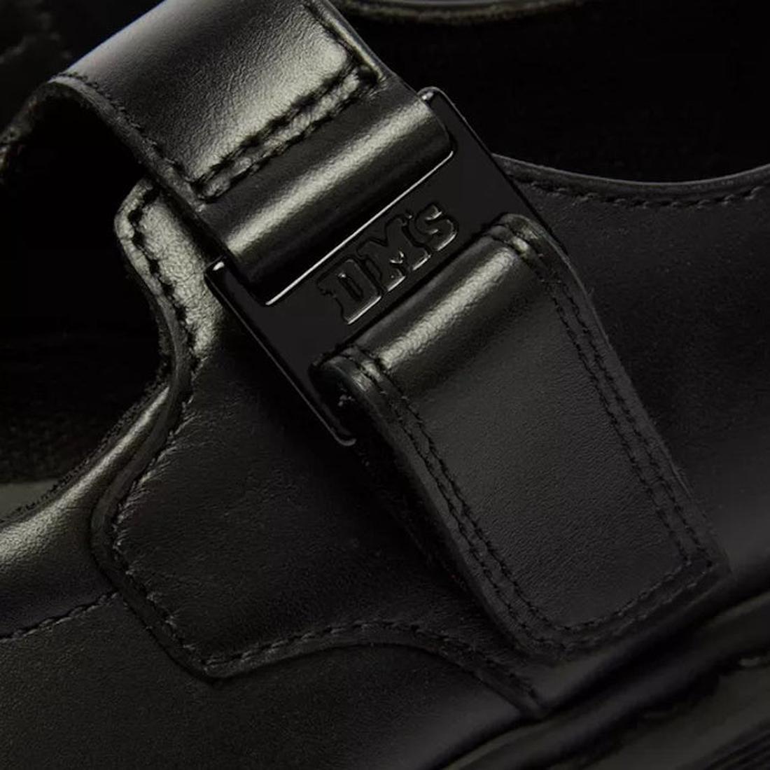 Close-up of the Dr Martens Bex Indica II Mary Jane Tech Nappa Mono Black, featuring a metal DMS-engraved buckle, precise stitching, and a smooth black leather finish., 190665804744, 190665804751, 190665804768, 190665804782, 190665804799, 190665804805, 503