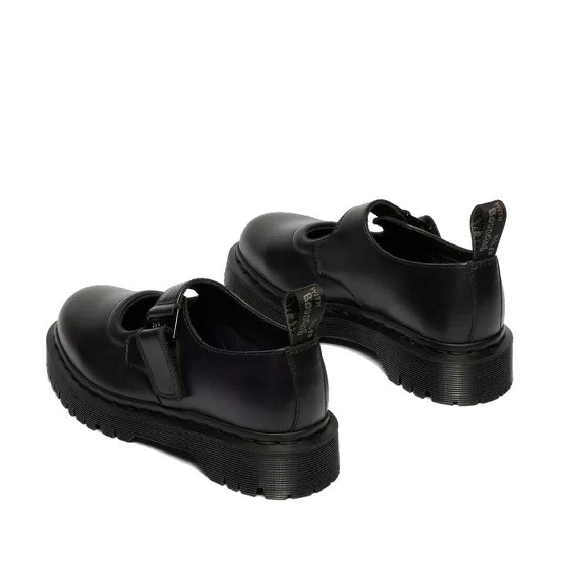 The Dr Martens Bex Indica II Mary Jane Tech Nappa Mono Black features thick, ridged soles, a single front strap with buckle, and branded pull tabs at the heel. Shown from a rear side angle., 190665804744, 190665804751, 190665804768, 190665804782, 19066580