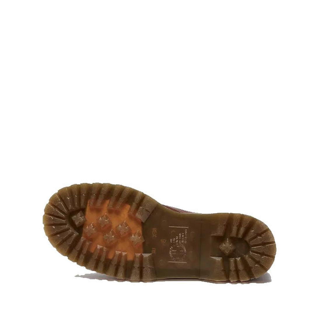 The Dr Martens Jadon Cashew Tan Ambassador Leather Zip Boot is shown sole up on a white background, highlighting its thick, rugged tread pattern and classic Jadon boot style., 190665749038, 190665749045, 190665749052, 190665749076, 190665749083, 190665749