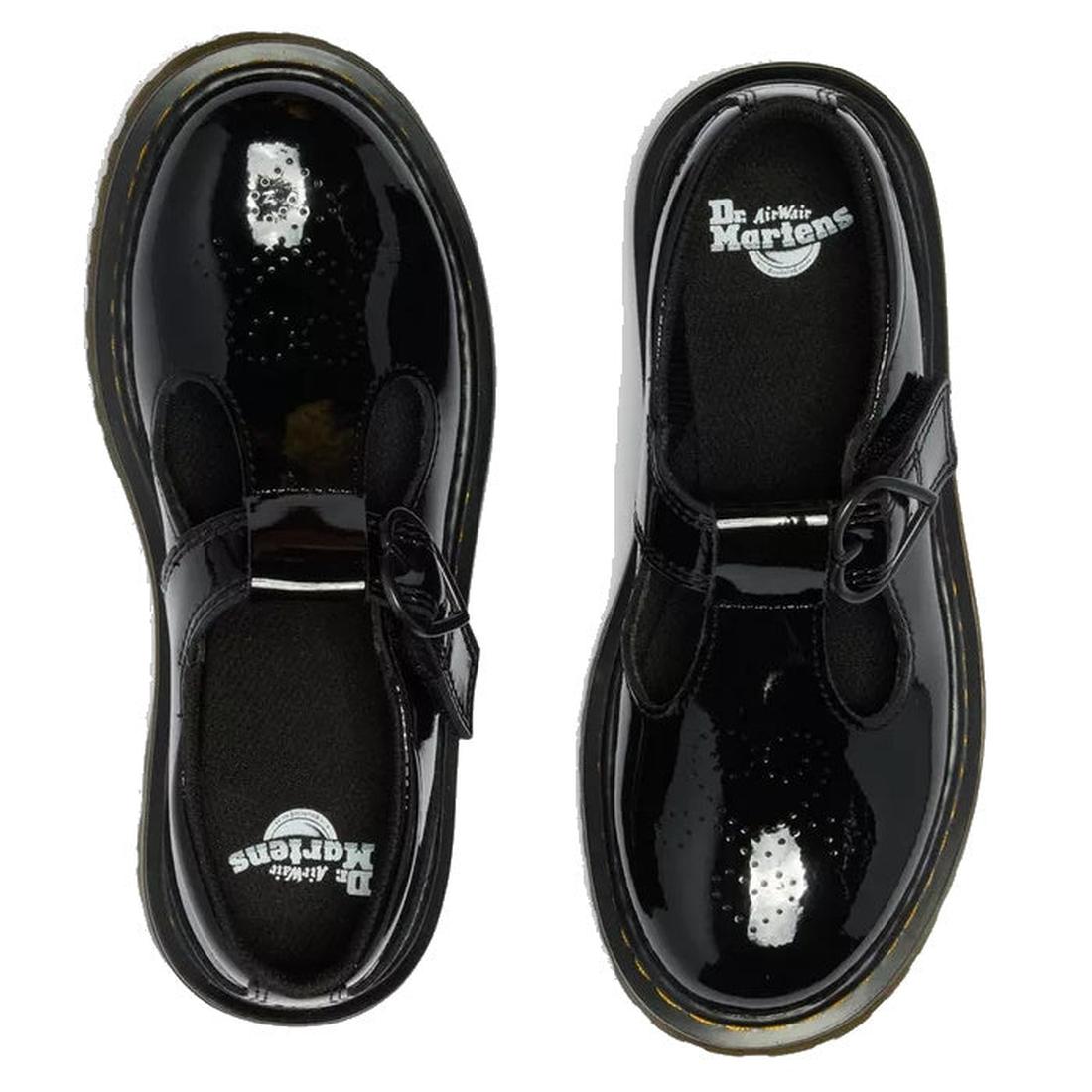 Top view of Dr Martens kids Polley II Heart T Bar Junior Black Patent shoes with shiny black patent leather, thick yellow-stitched soles, and buckle straps, placed side by side on a white background., 50432, 50433, 190665786743, 190665786750, 190665786651