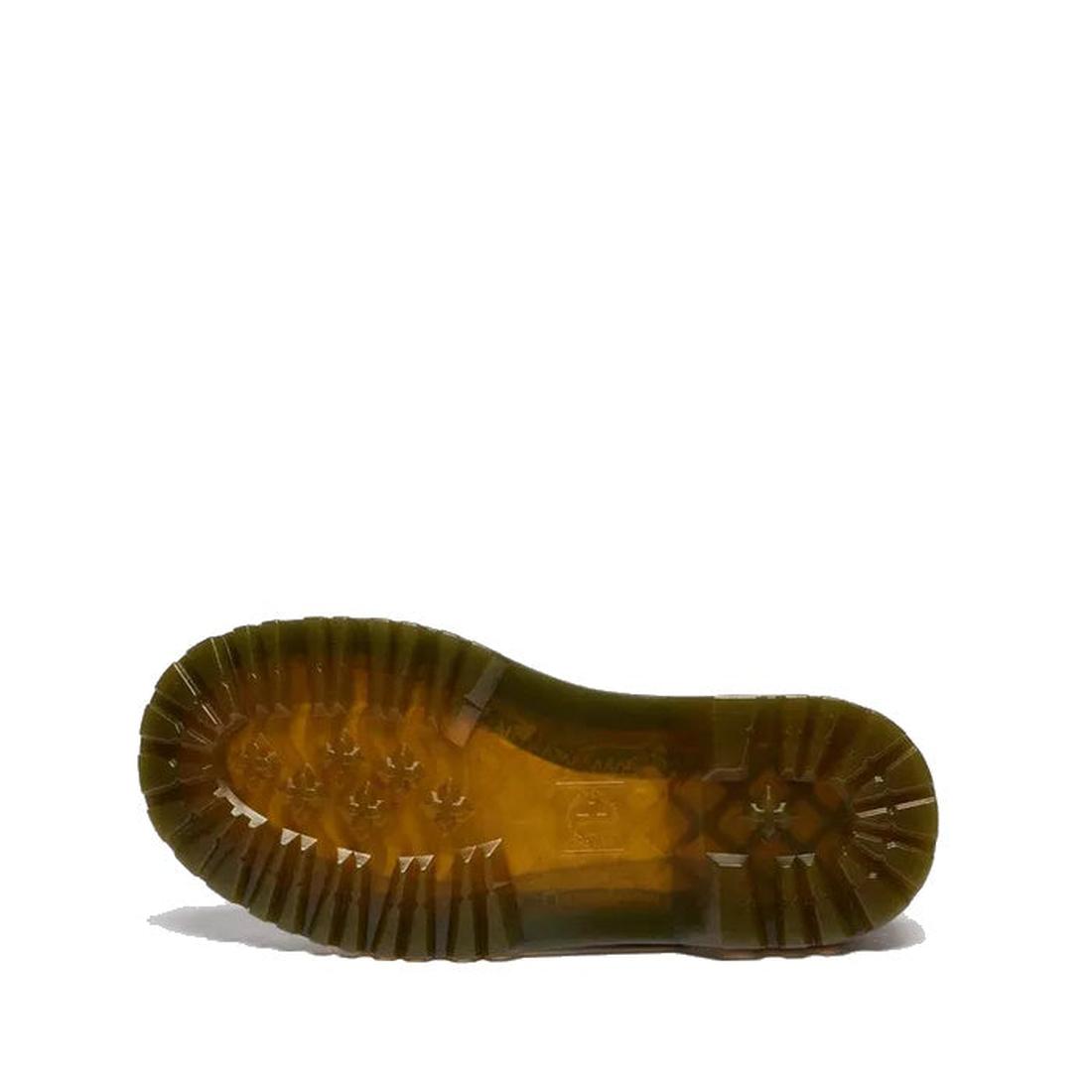 The image shows the bottom view of a Dr Martens kids Polley II Heart T Bar Junior Black Patent shoe, with a clear brown rubber sole featuring deep tread patterns for grip, placed on a white background., 50432, 50433, 190665786743, 190665786750, 1906657866