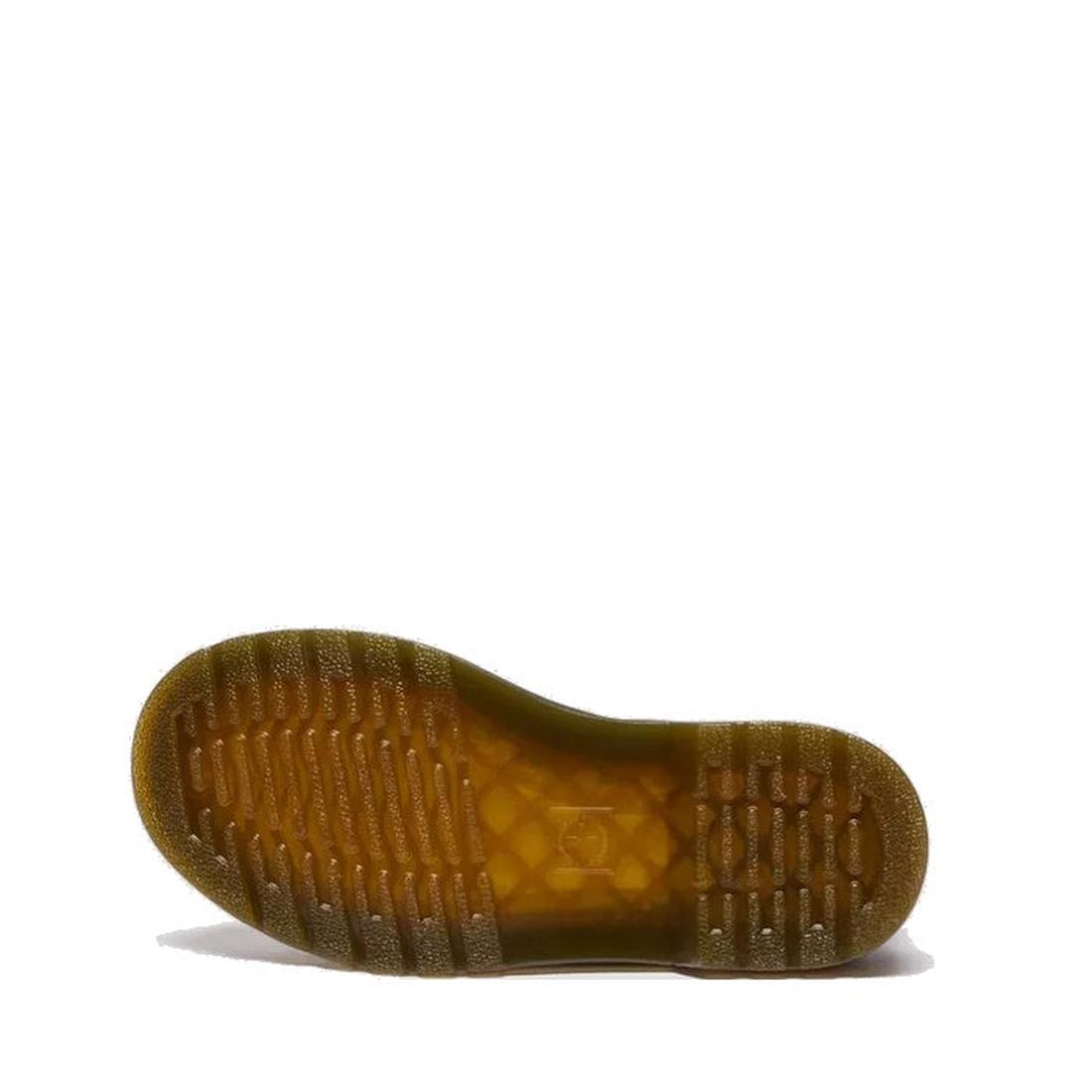 The image displays the translucent brownish rubber sole of the Dr Martens kids 1460 J Juniors Gingham Pink Lace Up Boot with zip, laid flat to show its tread with horizontal grooves and textured grip, against a plain white background., 50424, 50425, 50426