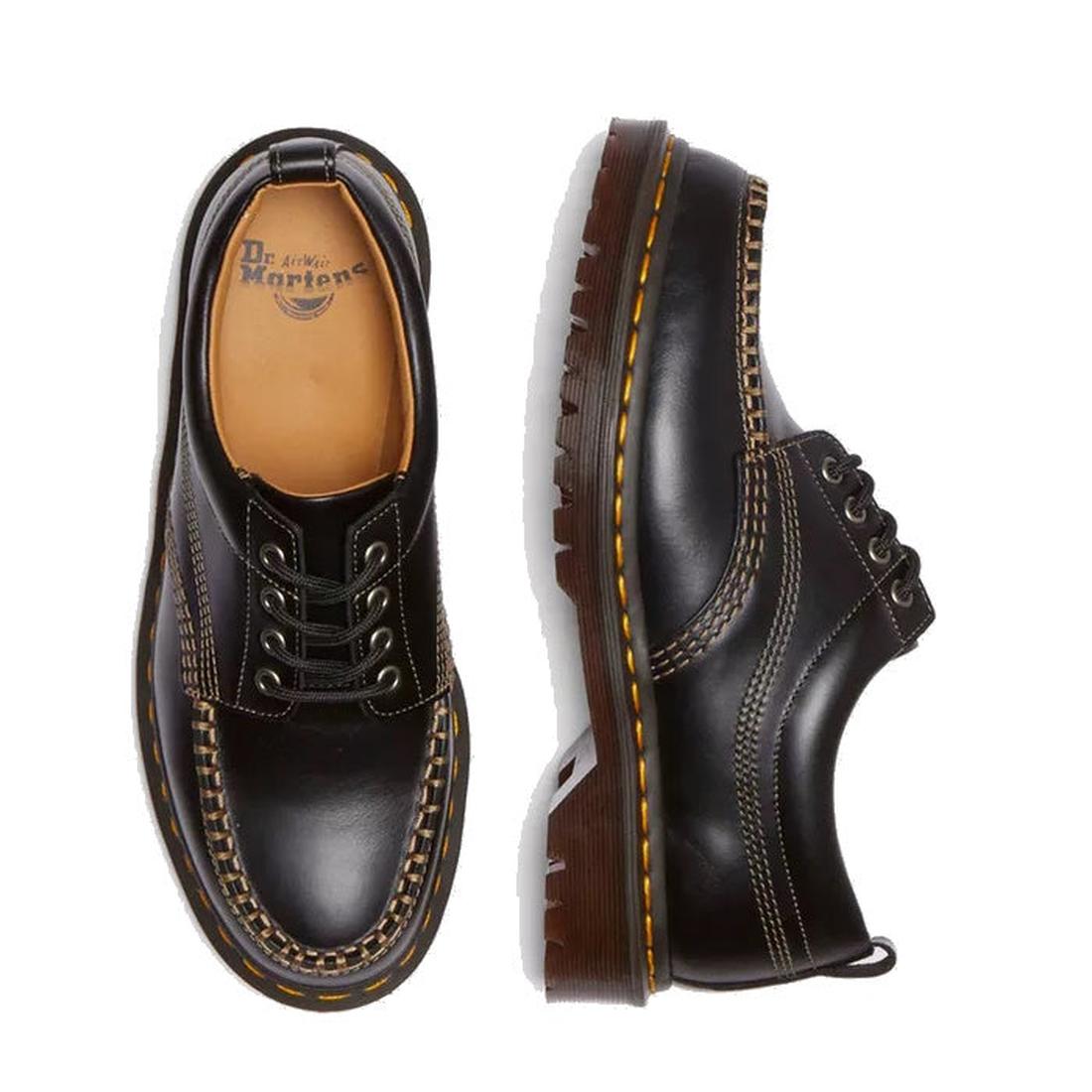 The Dr. Martens Lowell Moc Toe Black Leather Shoe features analine leather, yellow stitching, thick brown soles, and contrasting white details, shown from top and side views on a white background., 50395, 50396, 50397, 50398, 50399, 190665668940, 19066566