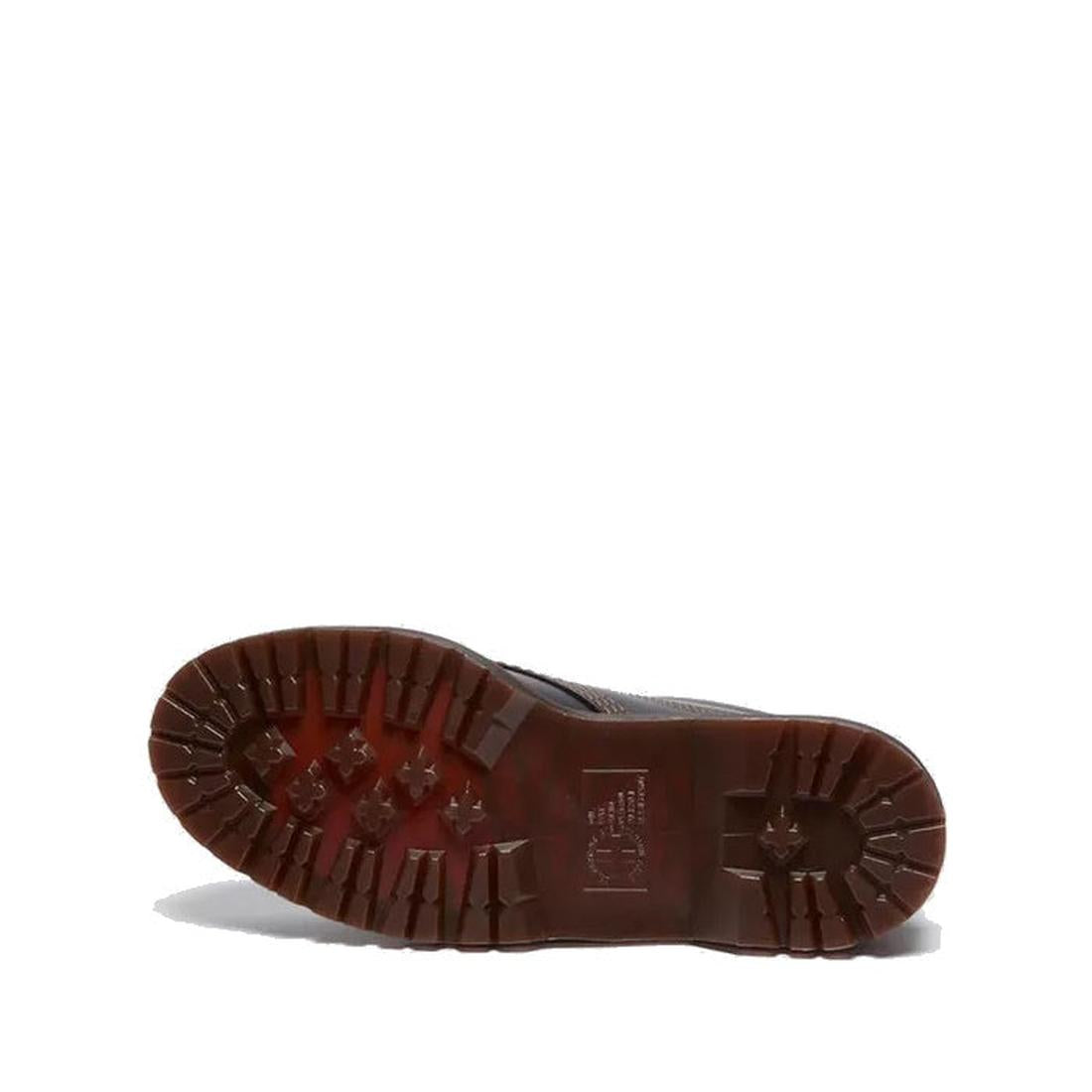 The image shows the sole of a Dr Martens Lowell Moc Toe Black Leather Shoe, featuring a dark brown tread with deep, rugged lugs for traction. The background is plain white., 50395, 50396, 50397, 50398, 50399, 190665668940, 190665668957, 190665668971, 1906