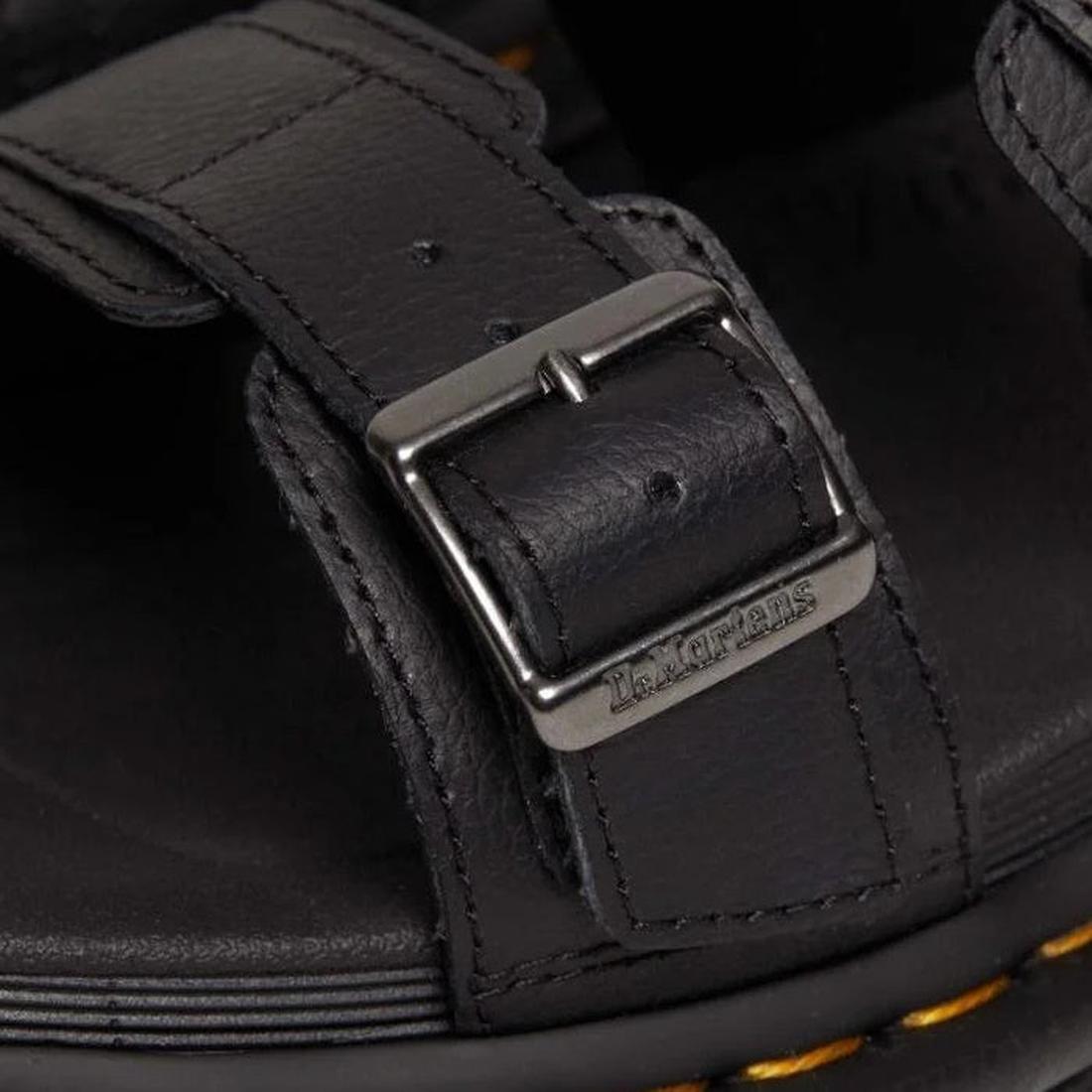A close up detail shot of a Dr Martens Myles sandal strap that goes over the toes with a chrome buckle with Dr Martens branding .,
190665653779,
190665653786,
190665653793,
190665653816,
190665653823,
190665653830,, 42798, 190665653779, 190665653786, 1906