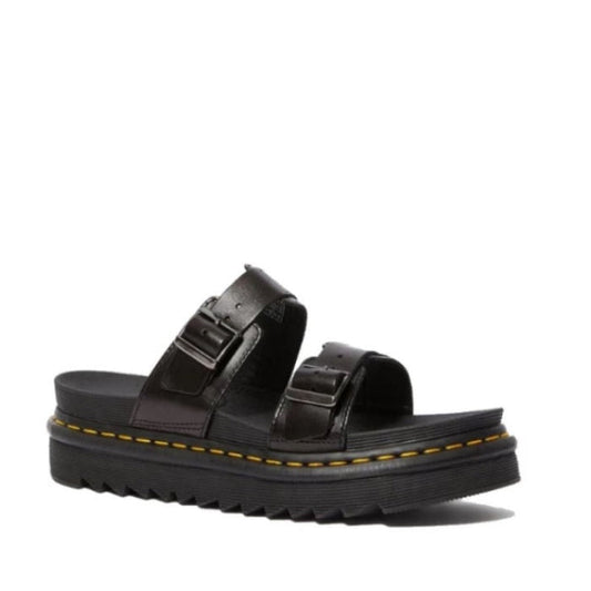 The Dr Martens Black Myles Black Bar Brando Sandal features two thick adjustable buckle straps, a chunky ridged sole, and yellow stitching on the Goodyear-welted base, shown against a plain white background.