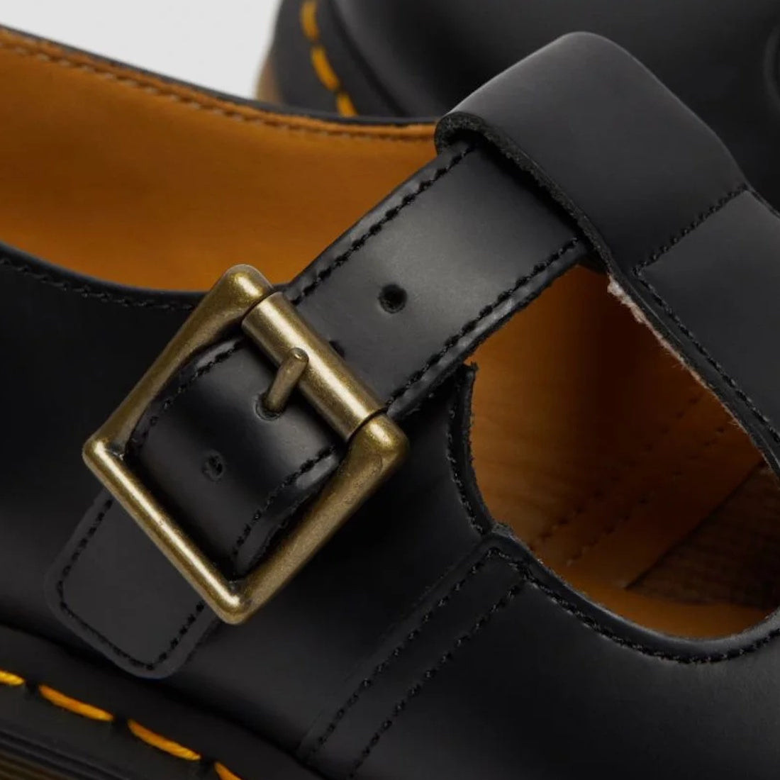 Close-up of a black Dr Martens polley brass looking buckle and t-bar strap over the top of the foot. Also part shoes the tan lining.
883985498242,
883985498259,
883985498266,
883985498273,
883985498280,
883985498297,
883985498303,
883985498310,, 883985498
