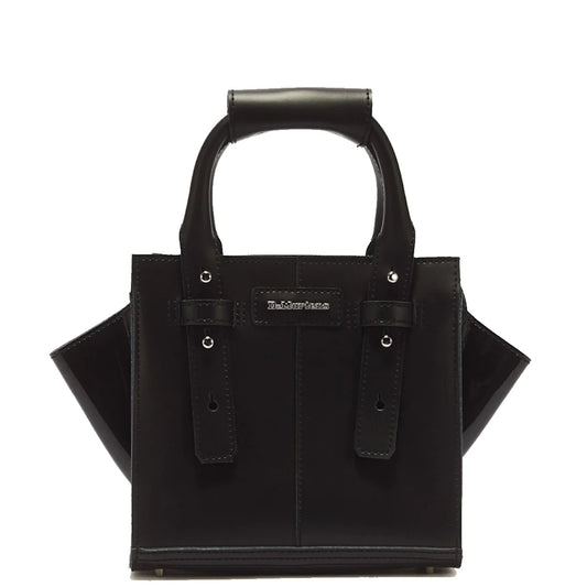 The Dr Martens Small Keiv Leather Tote Bag Black is a structured small tote crafted from black Kiev leather, featuring two top handles with decorative patent Lamper straps and a small rectangular logo patch on the front, shown against a white background.