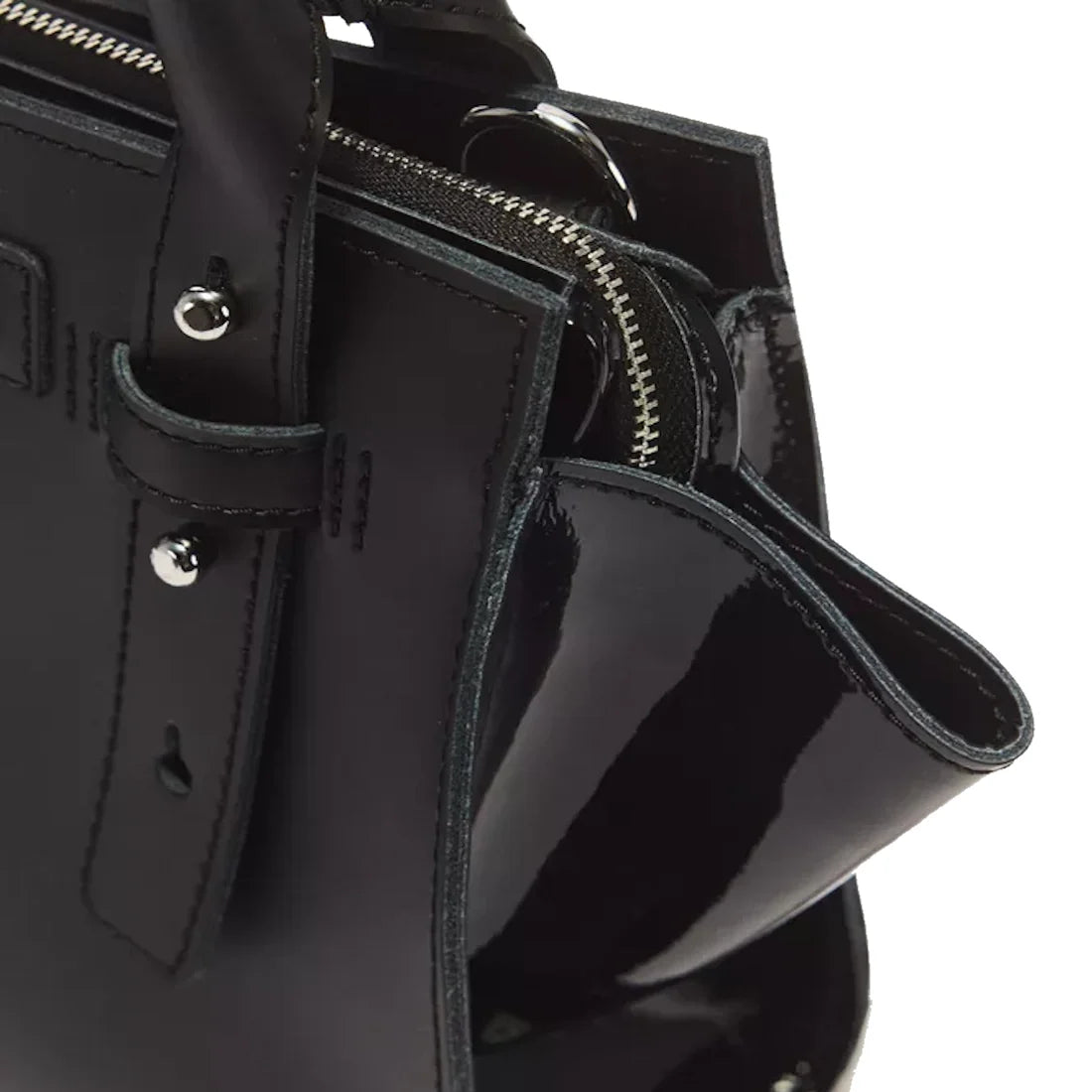 Close-up of the Dr Martens Small Keiv Leather Tote Bag in black, highlighting its handle with patent Lamper straps, silver zipper, metal studs, and glossy-finished side panel., 190665794915