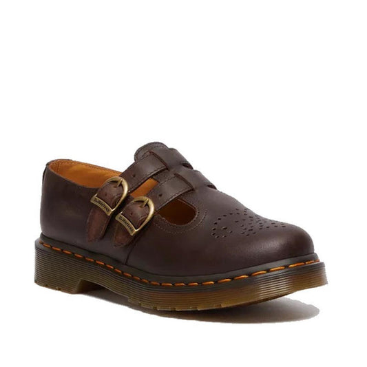 The Dr Martens 8065 2 Strap Mary Jane Shoe in Crazy Horse Brown features dual buckle straps, decorative toe cut-outs, signature yellow stitching, and a thick rubber sole.