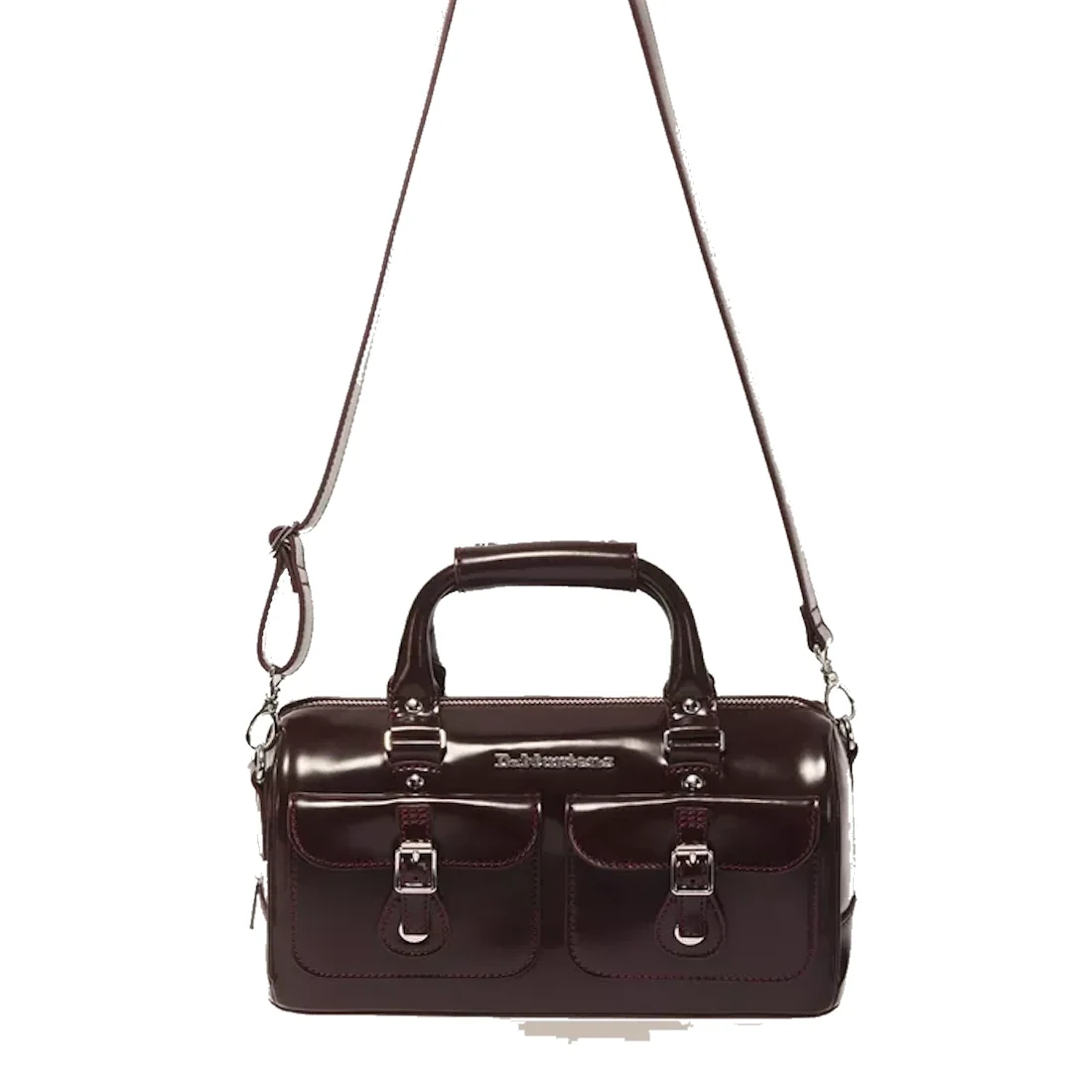 A cherry red Oxford Rub Off Dr Martens Top Handle Bag, featuring two front pockets, silver buckles, a signature top handle inspired by classic Dr Martens design, and an adjustable shoulder strap, photographed on a white background.
