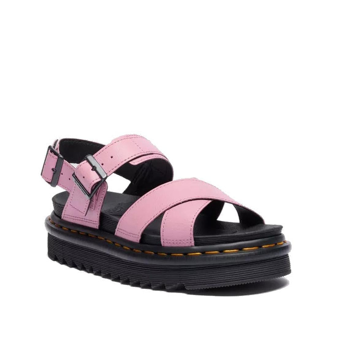 A single Dr Martens - Voss II Cross Strap Sandal in Dusty Rose Pink, with black buckles and a thick black sole with yellow stitching, is displayed on a white background.