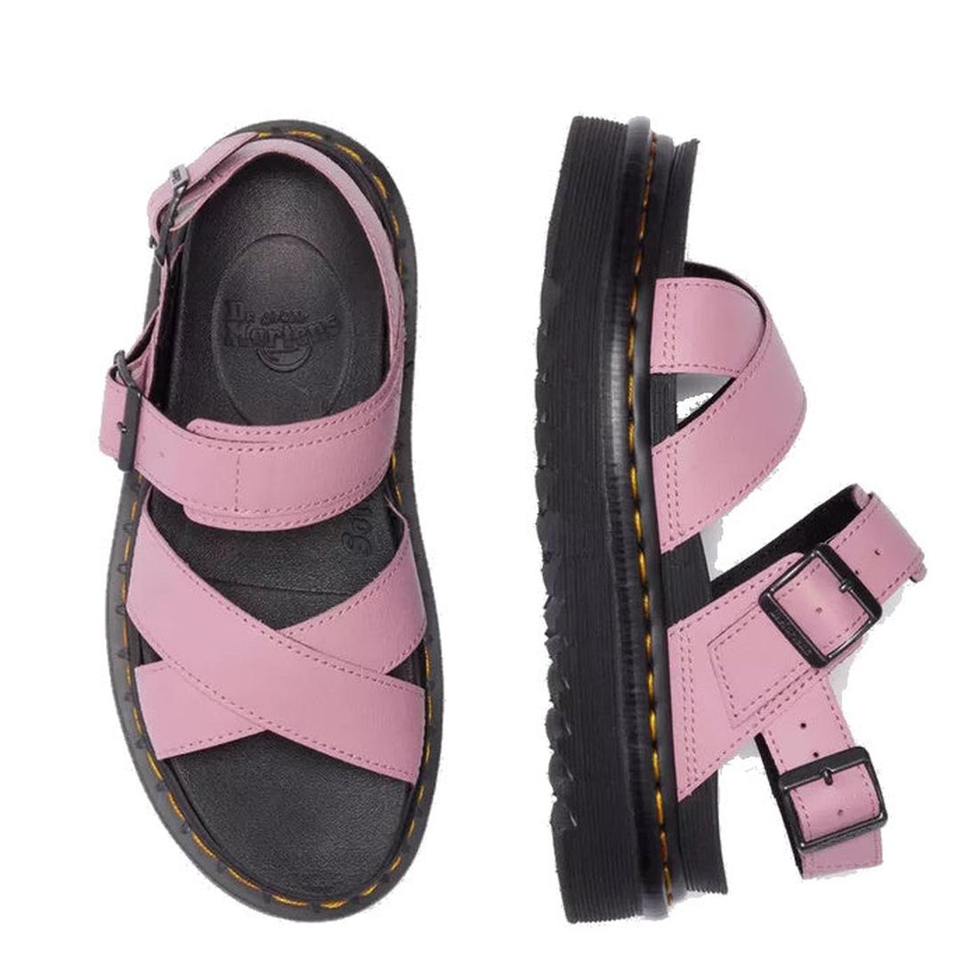 Dr Martens - Voss II Cross Strap Sandal in Dusty Rose Pink features black soles, crisscross straps, and buckle closures. The image shows one sandal from the top and another from the side., 50439, 190665777529, 190665777536, 190665777543, 190665777567, 504