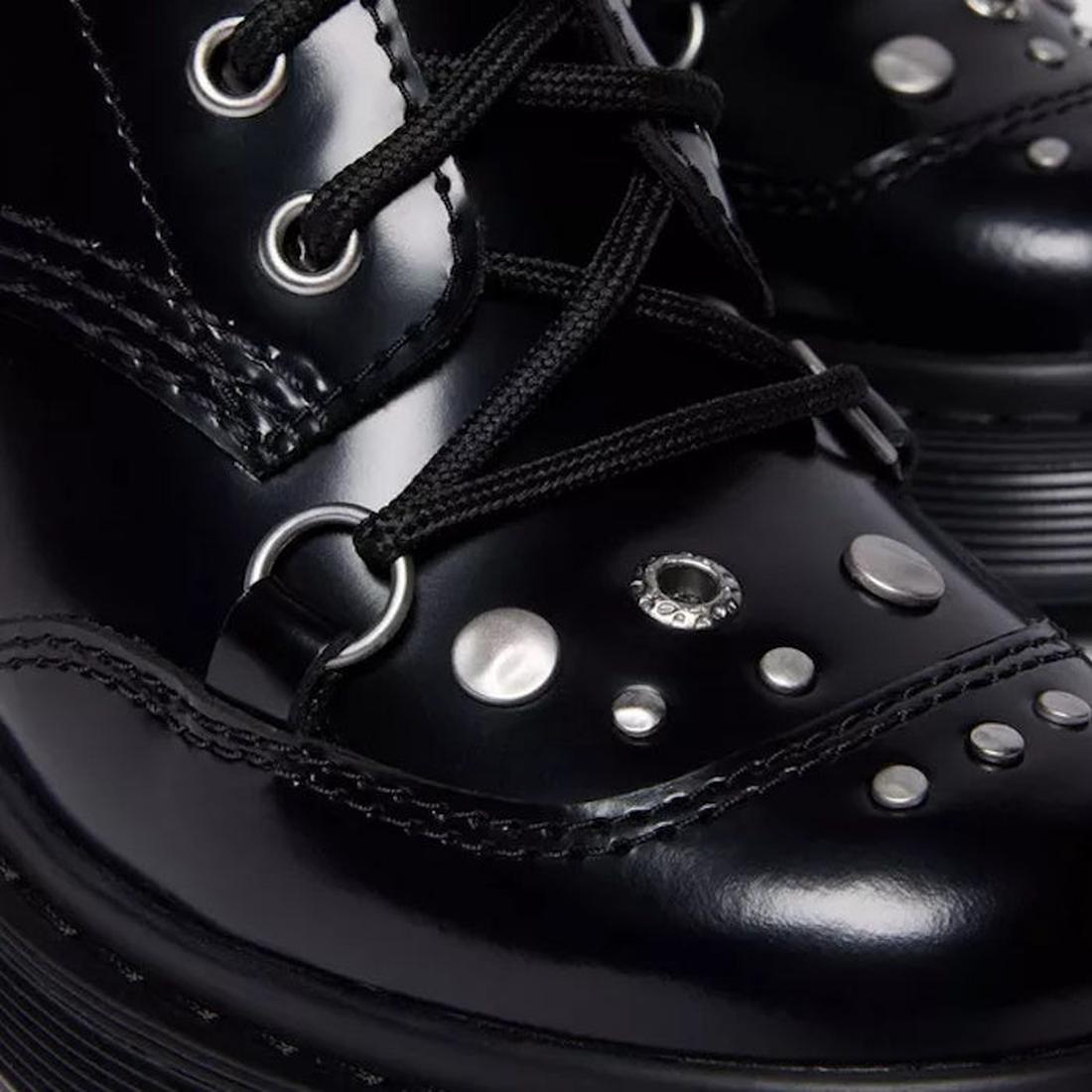Close-up of the toe of Dr martens chesney black leather boots with studs and laces. shoes leather buffer over the toe and studs.,190665797701,
190665797718,
190665797732,, 49579, 190665797701, 190665797718, 190665797732, 49583, 49584, 49585, 49586