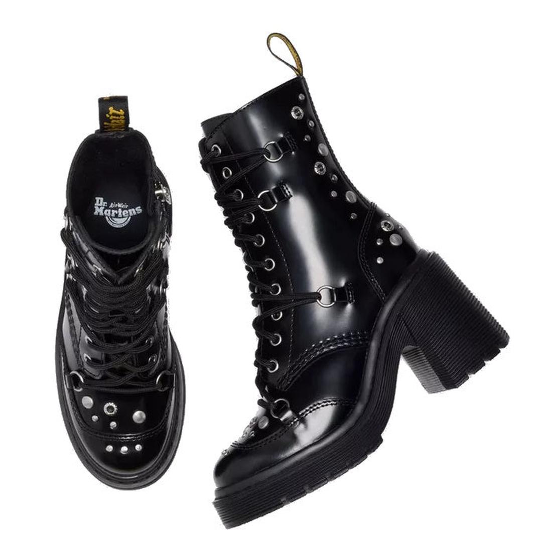 Dr Martens Chesney Hardware Black Leather Black leather boots with studded details on a white background. Top down of one boot showing detaul of studs on toe and dr martens logo ob the inner of the foot. The other boot side view showing the heel and platf