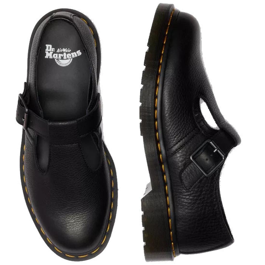 A flat lay of a pair od Dr Martens Polly T Bar Black leather shoes with buckle detail and yellow stitching around the sole on a white background, featuring Dr. Martens branding. Also showing the pebbled textured look in the leather.,
190665740530,
1906657