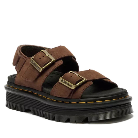 The Dr. Martens Zebzag Sepia Brown Nubuck 2 Strap Sandal features milled nubuck, two adjustable buckle straps, a thick black sole, and signature yellow stitching around the edge.