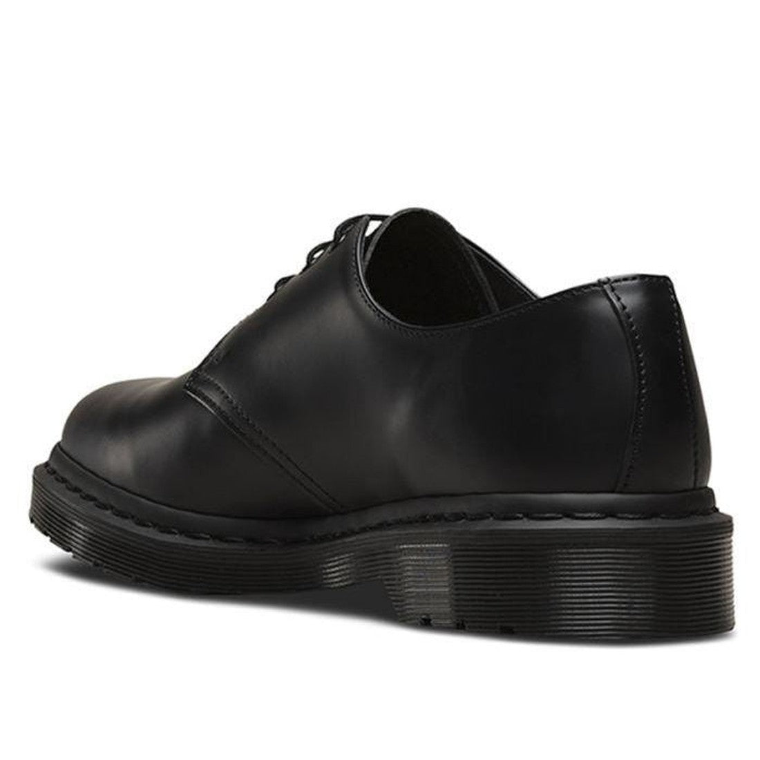 The Dr Martens 1461 Mono Black Smooth Shoe Oxford Lace Up, shown from the back-left angle on a white background, features black leather and a thick textured rubber sole reminiscent of the iconic style., 883985393523, 883985393547, 883985393530, 8839853935
